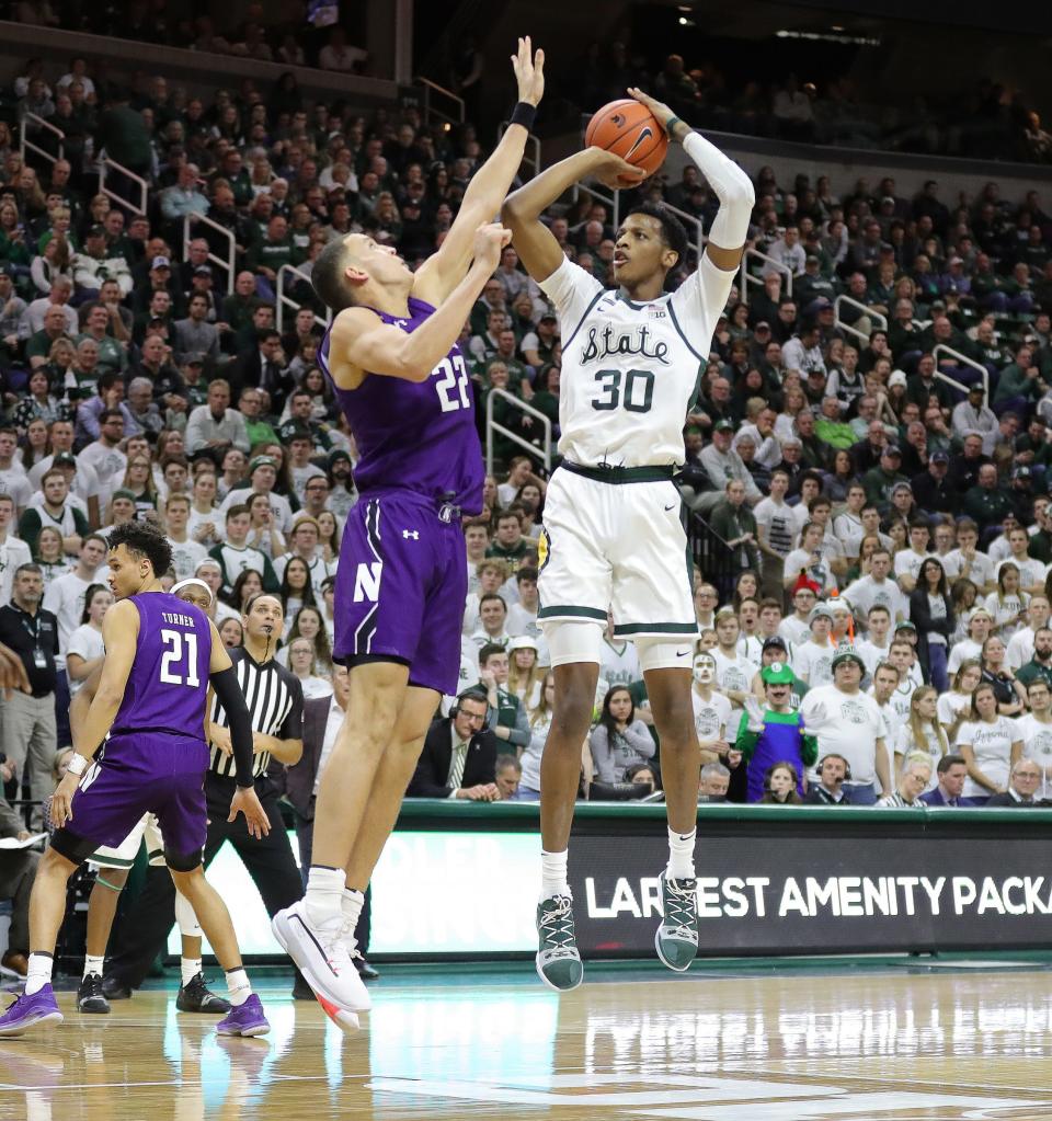 Michigan State forward Marcus Bingham Jr. scores against Northwestern forward Pete Nance during second half of MSU's 79-50 win on Wednesday, Jan. 29, 2020, at the Breslin Center.