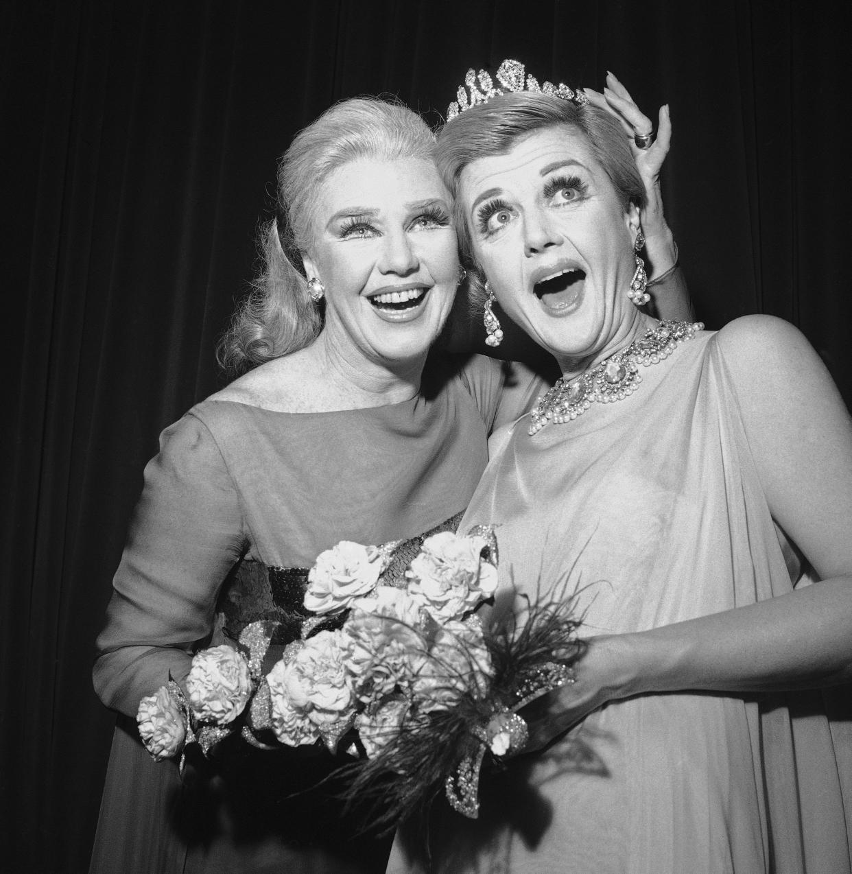 FILE - Ginger Rogers, left, star of the Broadway musical "Hello, Dolly" crowns Angela Lansbury, who's starring in "Mame," with the crown of Miss Ziegfeld 1967 on Dec. 2, 1966, at the 29th Ziegfeld charity ball. Rogers was the 1966 Miss Ziegfeld. Lansbury, the big-eyed, scene-stealing British actress who kicked up her heels in the Broadway musicals “Mame” and “Gypsy” and solved endless murders as crime novelist Jessica Fletcher in the long-running TV series “Murder, She Wrote,” died peacefully at her home in Los Angeles on Tuesday. She was 96. (AP Photo/Marty Lederhandler, File)