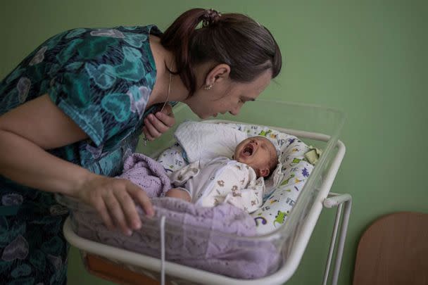 PHOTO: Elena, 36, checks on her baby Mikhail inside Pokrovsk maternity hospital, Donetsk region, eastern Ukraine, June 28, 2022. (Marko Djurica/Reuters)