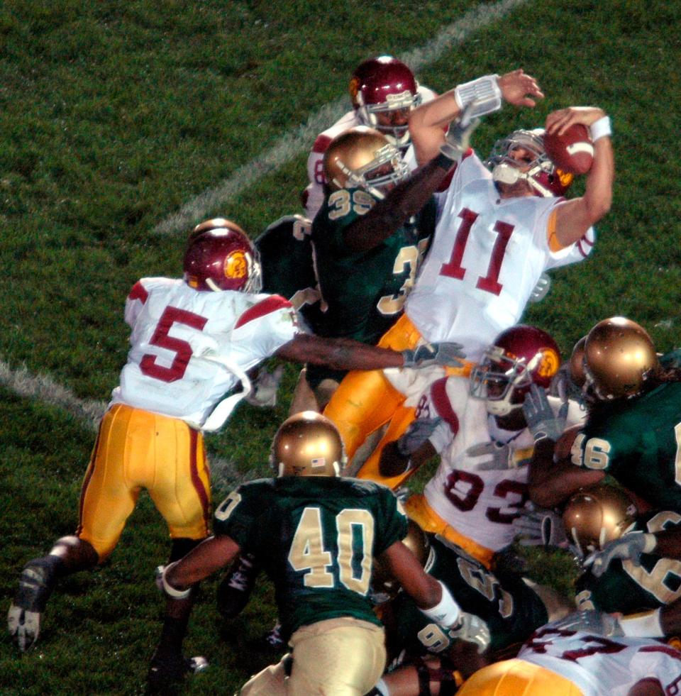 USC quarterback Matt Leinart, with a little help from Reggie Bush, tumbles into the end zone in the closing seconds of a classic in 2005.