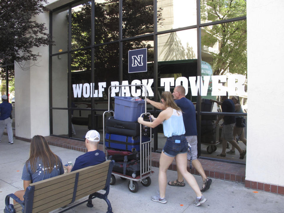 In this photo taken Thursday, Aug. 22, 2019, a student moves in to a Circus Circus casino-hotel tower that has been renamed Wolf Pack Tower in downtown Reno, Nev. It will house about 1,300 University of Nevada, Reno students for the coming school year after a July gas explosion shut down the two largest dorms on the main campus a half-mile away. (AP Photo/Scott Sonner)