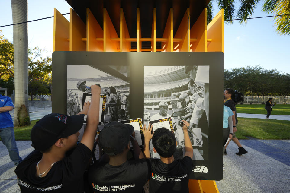 Kids from the Marlins Nike RBI youth sports program fill in worksheets about the life of late Major League Baseball player Roberto Clemente, as they visit a traveling exhibit titled "3000" in a nod to Clemente's 3000 career hits, at Miami Marlins' loanDepot Park in Miami, Wednesday, Jan. 31, 2024. The tribute to the Pittsburgh Pirates outfielder will be on display at the park during baseball's Caribbean Series, which runs from Feb. 1 through Feb. 9. (AP Photo/Rebecca Blackwell)