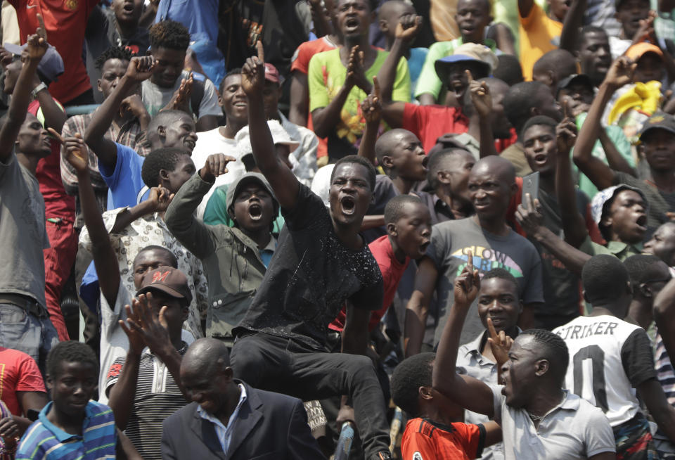 Mourners sing and dance as they sit in the stadium to pay their last respects at the coffin of former Zimbabwean President Robert Mugabe at the Rufaro Stadium in Harare, Friday, Sept. 13, 2019, where the body is on view at the stadium for a second day. Mugabe died last week in Singapore at the age of 95. He led the southern African nation for 37 years before being forced to resign in late 2017. (AP Photo/Themba Hadebe)