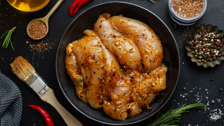 Chicken breasts being marinated