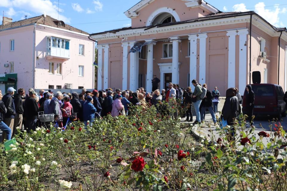 <div class="inline-image__caption"><p>Civilians line up to receive humanitarian aid supplies in Izyum.</p></div> <div class="inline-image__credit">Tom Mutch</div>