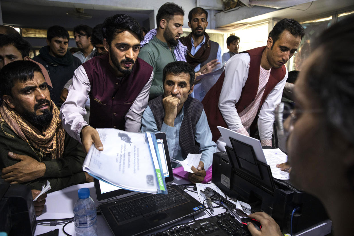 Afghans crowd into the Herat Kabul Internet cafe seeking help applying for Afghan Special Immigrant Visas on Aug. 8, 2021, in Kabul. (Paula Bronstein / Getty Images)