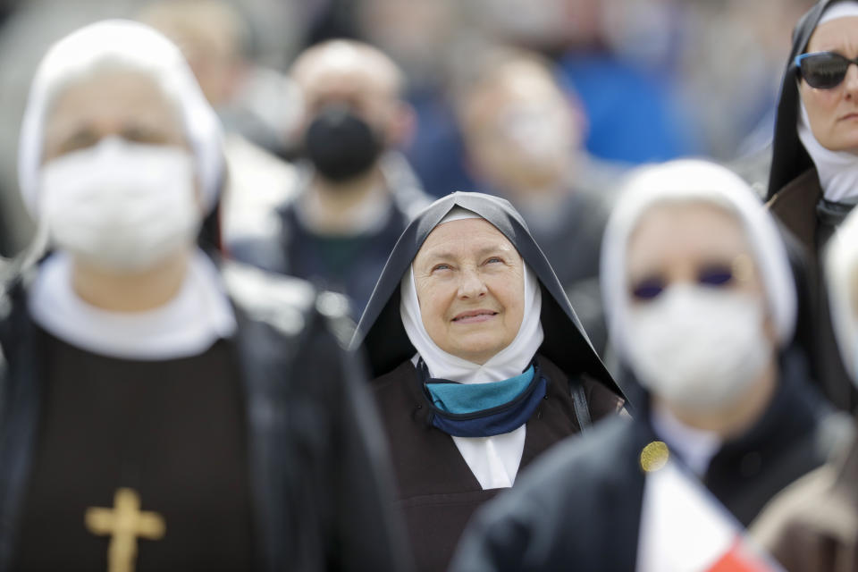 Nuns watch Pope Francis as he recites the Regina Caeli noon prayer from the window of his studio overlooking St.Peter's Square, at the Vatican, Sunday, April 18, 2021. Pope Francis said he is happy to be back greeting the faithful in St. Peter’s Square faithful for his traditional Sunday noon blessing after weeks of lockdown measures. (AP Photo/Andrew Medichini)