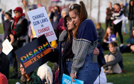 Valerie Stanley (L) and Ashley Torr hug as teens kick off a voter registration rally, a day ahead of the 19th anniversary of the massacre at Columbine High School, in Littleton, Colorado, U.S., April 19, 2018. REUTERS/Rick Wilking