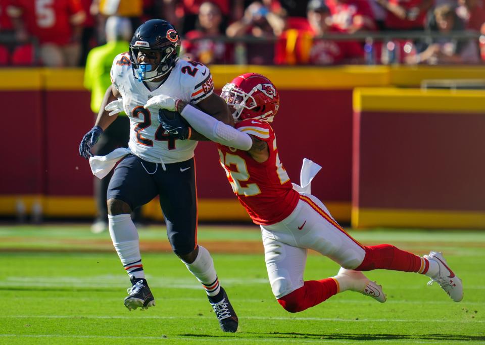 Chicago Bears running back Khalil Herbert (24) fumbles as he is tackled by Kansas City Chiefs cornerback Trent McDuffie (22) during the first half at GEHA Field at Arrowhead Stadium.