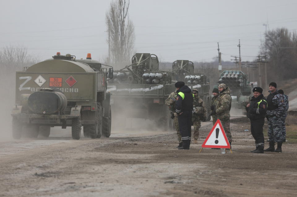 Russian Army military vehicles drive along a street, after Russian President Vladimir Putin authorized a military operation in eastern Ukraine, in the town of Armyansk, Crimea, February 24, 2022. REUTERS/Stringer