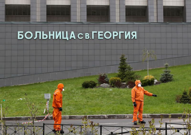 Emergency specialists work on a site of fire, that killed five novel coronavirus patients in an intensive care unit, at a hospital in Saint Petersburg