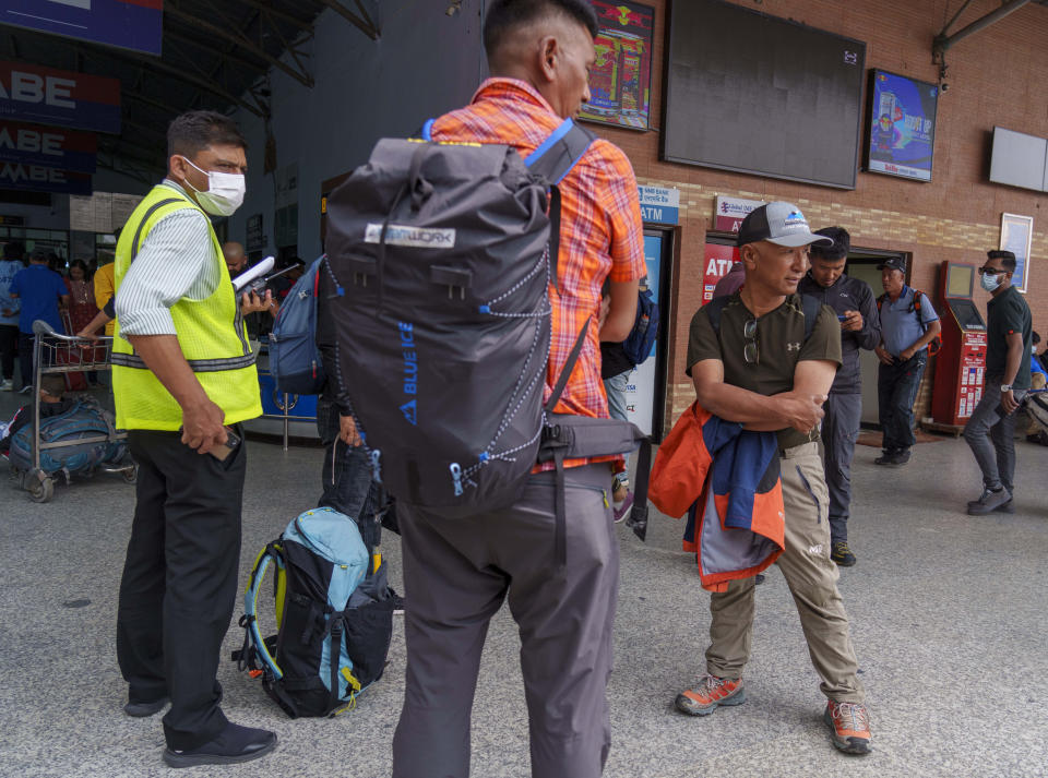 A team of climbers prepare to leave for rescue operations from the Tribhuvan International Airport in Kathmandu, Nepal, Sunday, May 29, 2022. A small airplane with 22 people on board flying on a popular tourist route was missing in Nepal’s mountains on Sunday, an official said. The Tara Airlines plane, which was on a 15-minute scheduled flight to the mountain town of Jomsom, took off from the resort town of Pokhara, 200 kilometers (125 miles) east of Kathmandu. It lost contact with the airport tower shortly after takeoff. (AP Photo/Niranjan Shreshta)