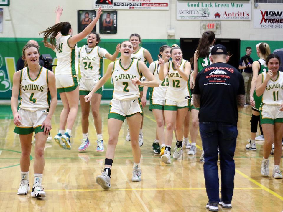 Newark Catholic celebrates after beating Waterford 62-61 in overtime last Monday.