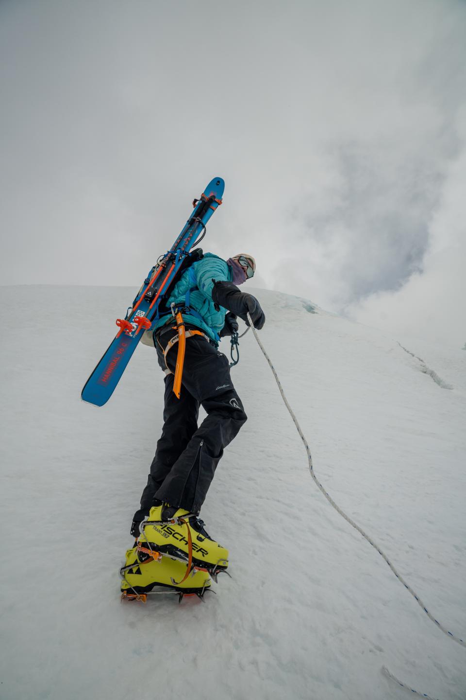 adrian ballinger wearing his skis on his back as he puts rope along the summit ridge of Makalu