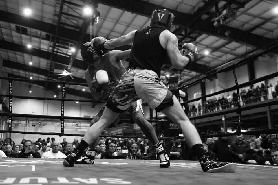 <p>Emergency Medical Services member Fabian Zavala, right, lands a punch on NYPD officer Billy Ramirez during the “Bronx Tough Turkey Tussle” at the New York Expo Center in the Bronx, New York, on Nov. 16, 2017. (Photo: Gordon Donovan/Yahoo News) </p>