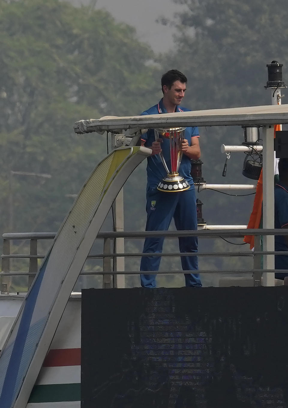 Australia's captain Pat Cummins holds the ICC Men's Cricket World Cup trophy during a photo shoot on a cruise boat in the Sabarmati River a day after winning final match against India in Ahmedabad, India, Monday, Nov. 20, 2023. (AP Photo/Mahesh Kumar A.)
