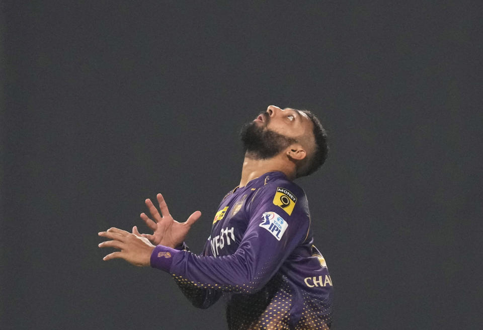 Kolkata Knight Riders' Varun Chakravarthy follows the ball to take a catch that resulted in the dismissal of Royal Challengers Bangalore's Akash Deep during the Indian Premier League (IPL) cricket match between Royal Challengers Bangalore and Kolkata Knight Riders in Kolkata, India, Thursday, April 6, 2023. (AP Photo/Bikas Das)