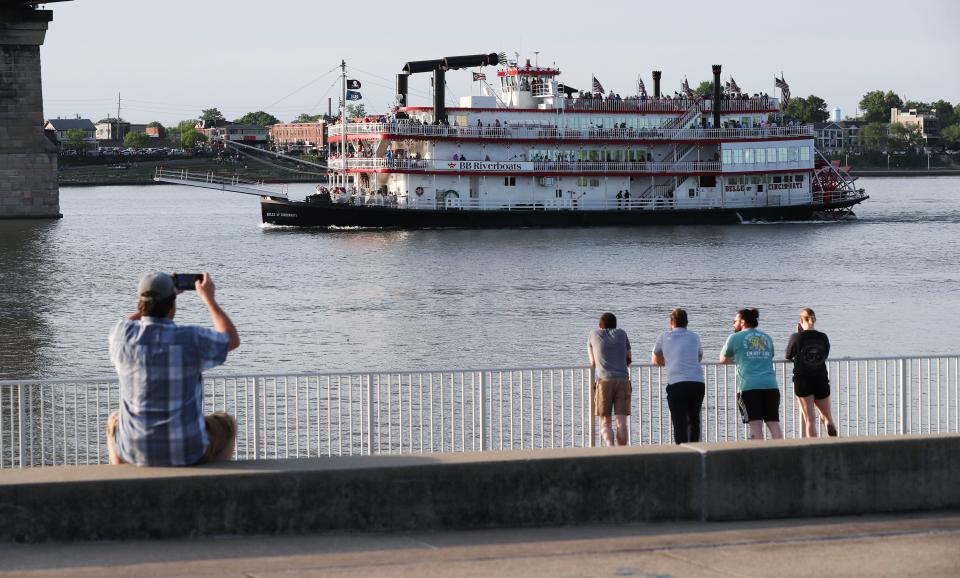 Spectators watched from the Big Four Lawn as the Belle of Cincinnati took the lead against Belle of Louisville during the Great Steamboat Race on the Ohio River in Louisville, Ky. on May. 1, 2024.