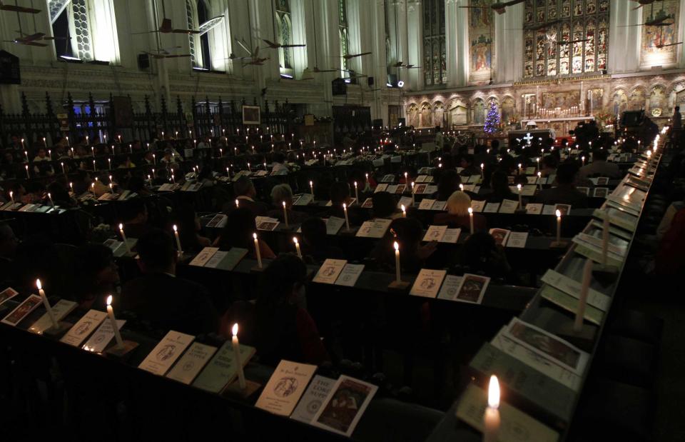 People attend a Christmas Eve mass at St. Paul's Cathedral in Kolkata