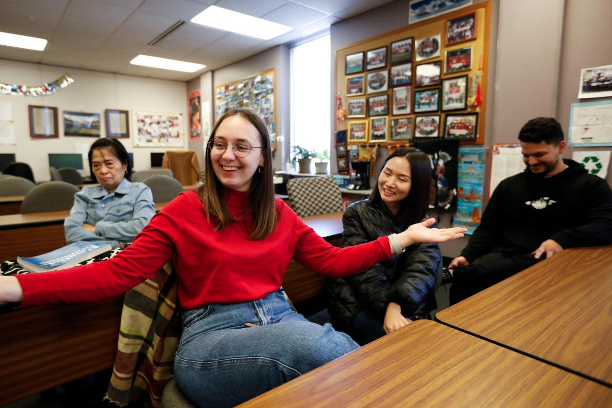 Ozarks Technical Community College English as a Second Language (ESL) students Hanna Vlasin of Ukraine (front), Shan He of China (center right), Luis Hernandez of Venezuela, and Mya Khin of Myanmar (back left) talk about their excitement for having a traditional Thanksgiving meal in their Graff Hall classroom with their instructor Fran Giglio.