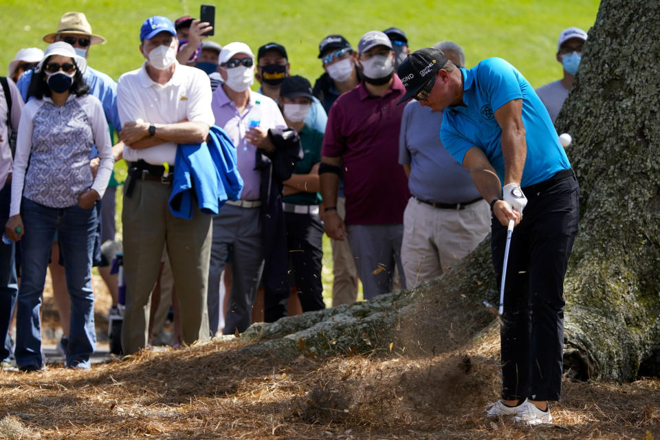 Brian Gay hits from the pine straw on the 18th hole during the first round of the The Players Championship golf tournament Thursday, March 11, 2021, in Ponte Vedra Beach, Fla. (AP Photo/John Raoux)