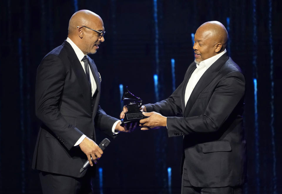 Harvey Mason Jr., CEO of the Recording Academy, left, presents the Recording Academy global impact award to Dr. Dre at the Black Music Collective on Thursday, Feb. 2, 2023, at The Hollywood Palladium in Los Angeles. (AP Photo/Chris Pizzello)