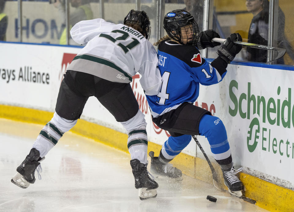 Boston's Hilary Knight (21) checks Toronto's Renata Fast (14) into the boards during the first period of a PWHL hockey game in Toronto, Wednesday March 6, 2024. (Frank Gunn/The Canadian Press via AP)