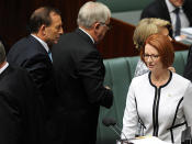 <p>Tony Abbott walks by Julia Gillard during Question Time.</p>