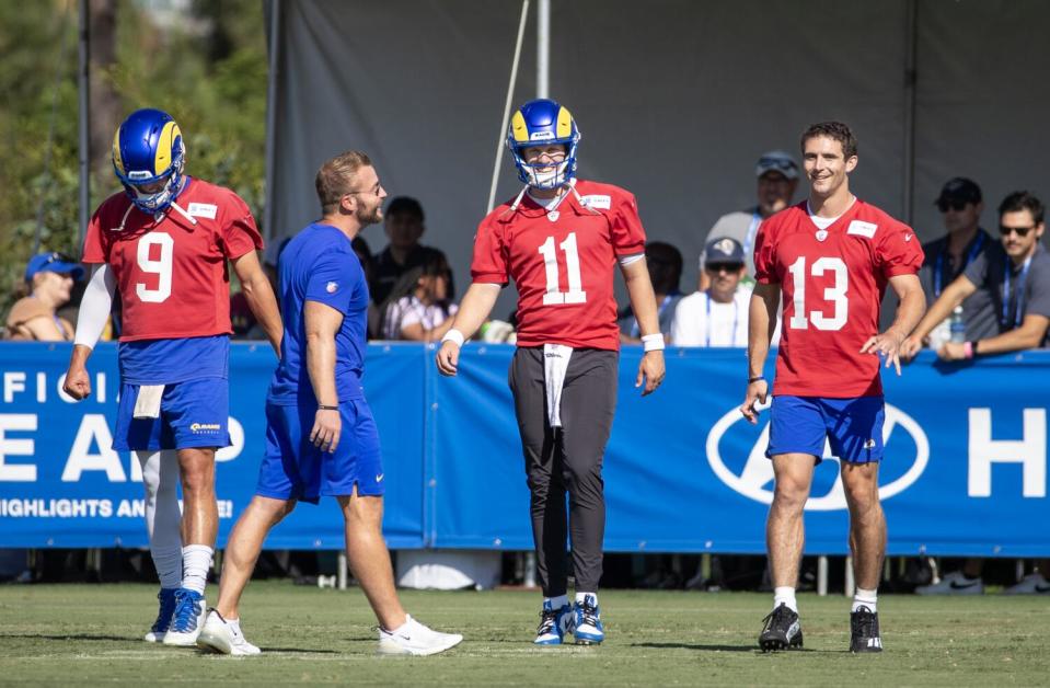 Rams coach Sean McVay talks to quarterbacks (from left) Matthew Stafford, Brett Rypien and Stetson Bennett.