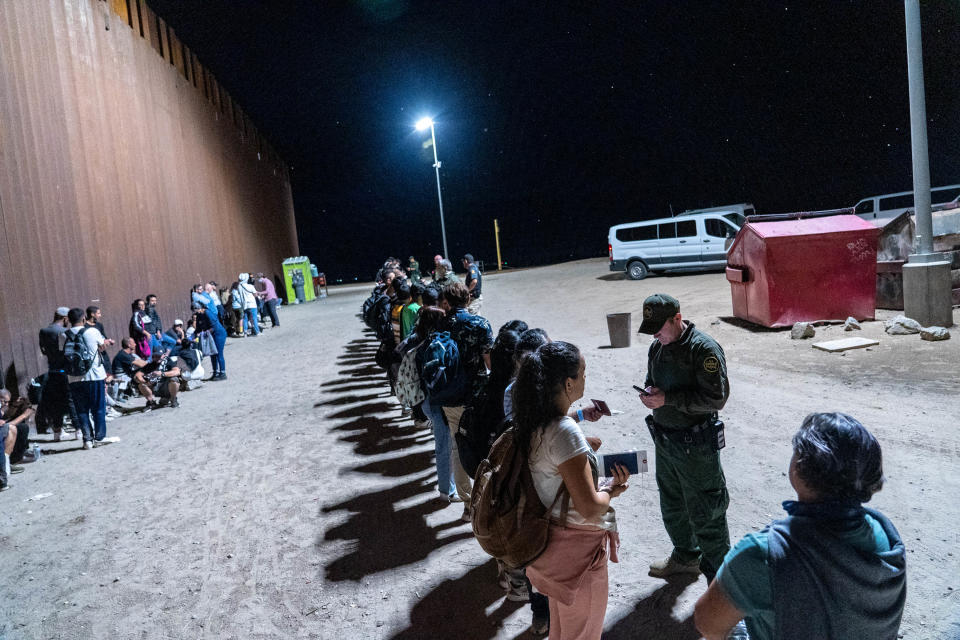 Migrants and asylum seekers are detained by U.S. Border Patrol agents after crossing the U.S.-Mexico border in Yuma County, Arizona, near the Cocopah Indian Tribe's reservation on July 28, 2022.