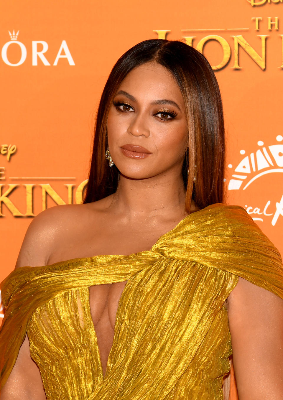 Beyoncé wearing a gold pleated off-the-shoulder gown at 'The Lion King' premiere