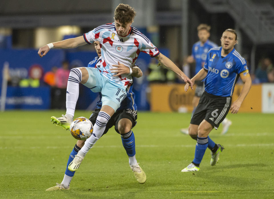 CF Montreal's Joel Waterman (16) grabs Chicago Fire's Brian Gutierrez (17) from behind as he tries to take the ball during the first half of an MLS soccer match in Montreal, Saturday, Sept. 16, 2023. (Peter McCabe/The Canadian Press via AP)