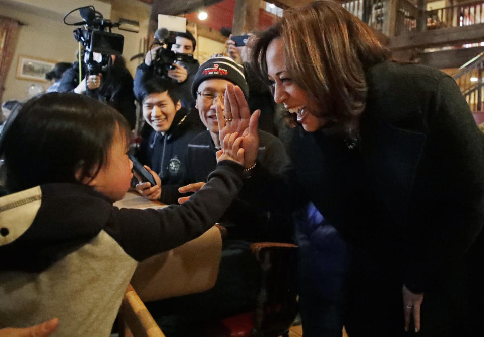 Democratic presidential candidate Sen. Kamala Harris, D-Calif., high-fives with 2-year-old Isabelle Chan of Newton, Mass. at the Common Man Restaurant, Monday, Feb. 18, 2019, in Concord, N.H. (AP Photo/Elise Amendola)