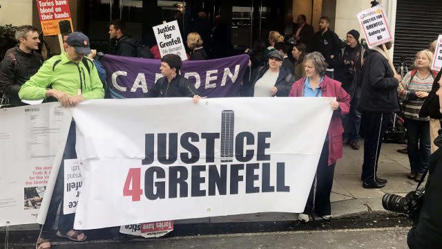 Protesters outside the Grenfell Tower public inquiry in central London where Sir Martin Moore-Bick is delivered his opening statement