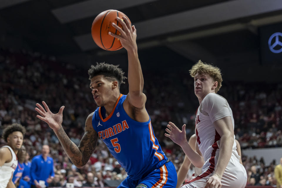 Florida guard Will Richard (5) grabs a rebound in front of Alabama forward Sam Walters, rightk, during the first half of an NCAA college basketball game Wednesday, Feb. 21, 2024, in Tuscaloosa, Ala. (AP Photo/Vasha Hunt)