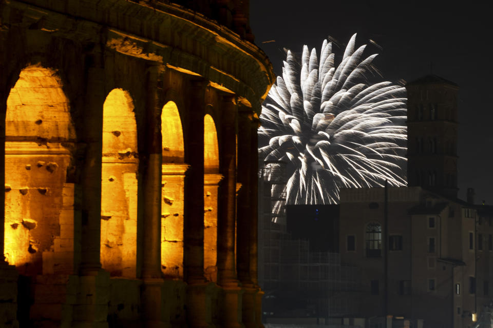 Fireworks explode in the sky next to Rome's Colosseum during New Year's celebrations, in Rome, Friday, Jan. 1, 2021. Italy went into a modified nationwide lockdown for the Christmas and New Year period, with restrictions on personal movement and commercial activity similar to the 10 weeks of hard lockdown Italy imposed from March to May when the country became the epicenter of the outbreak in Europe. (AP Photo/Andrew Medichini)