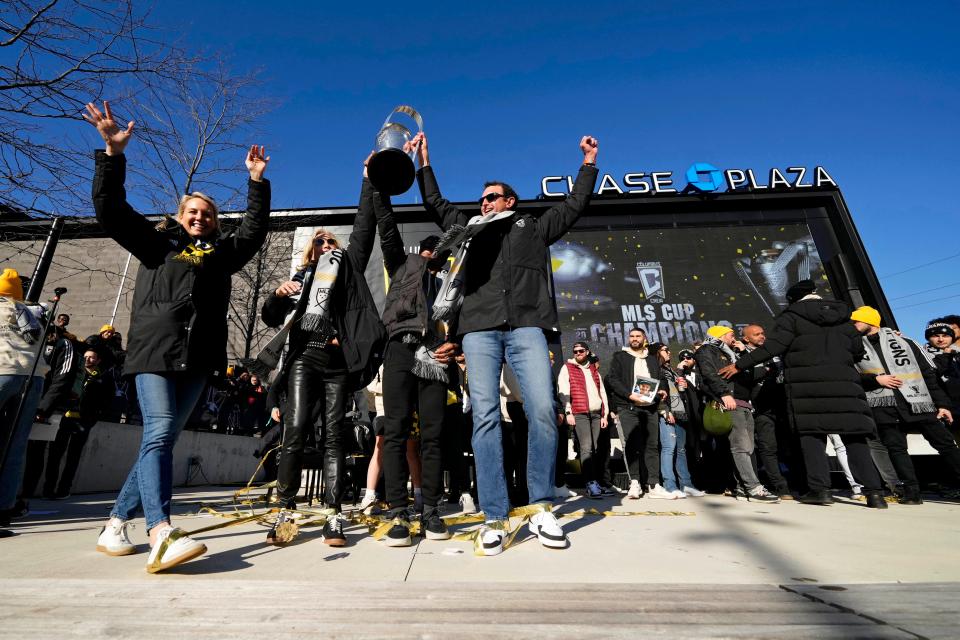 Crew general manager Issa Tall (center) lifts the Philip F. Anschutz Trophy during the team's celebration of its 2023 MLS Cup victory.