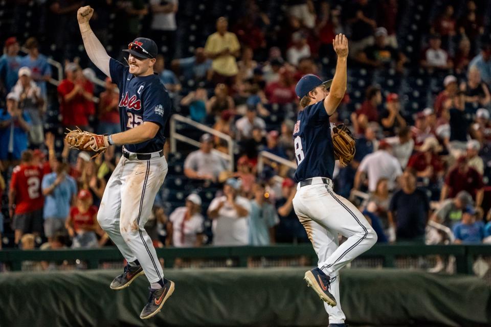 Jun 20, 2022; Omaha, NE, USA; Ole Miss Rebels first baseman Tim Elko (25) and center fielder Justin Bench (8) celebrate after topping the Arkansas Razorbacks at Charles Schwab Field. Mandatory Credit: Dylan Widger-USA TODAY Sports