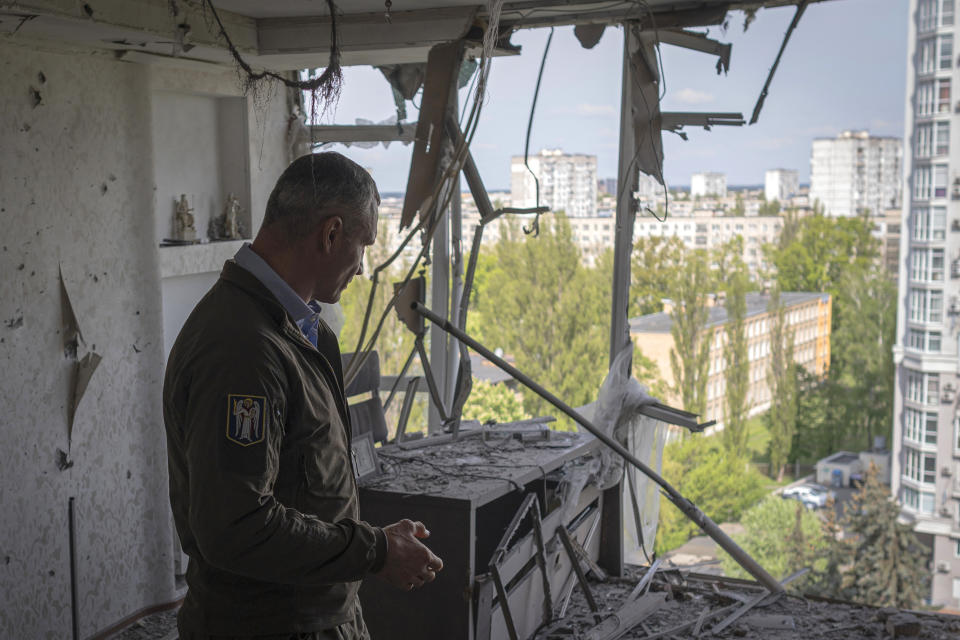 Kyiv Mayor Vitali Klitschko reacts standing in an apartment building damaged by a drone that was shot down during a Russian overnight strike, amid Russia's attack, in Kyiv, Ukraine, Monday, May 8, 2023. (AP Photo/Andrew Kravchenko)