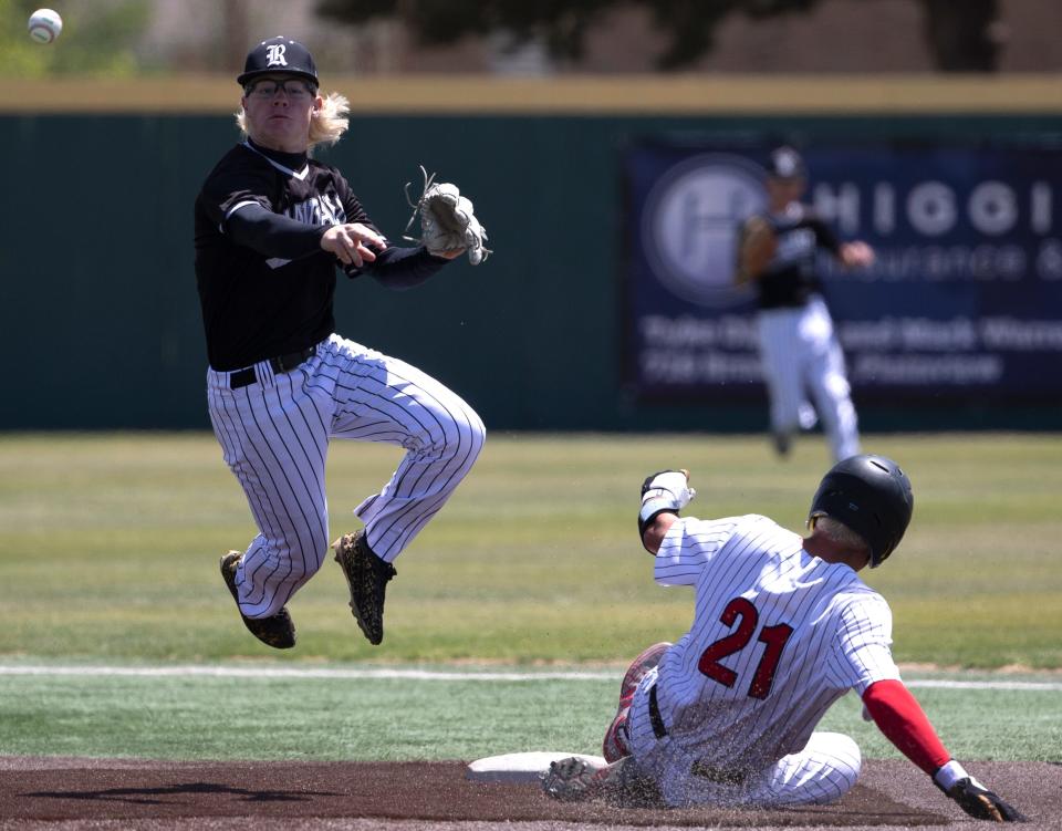 Randall's Payton Bush, left, throws to first base after getting Lubbock-Cooper's Holt Gibson out at second in the Region I-5A quarterfinal series, Saturday, May 21, 2022, at Wilder Park at Wayland Baptist University in Plainview. Lubbock-Cooper won, 9-1.