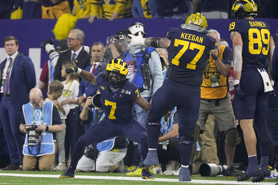 Michigan running back Donovan Edwards celebrates after scoring against Washington during the first half of the national championship NCAA College Football Playoff game Monday, Jan. 8, 2024, in Houston. (AP Photo/Eric Gay)