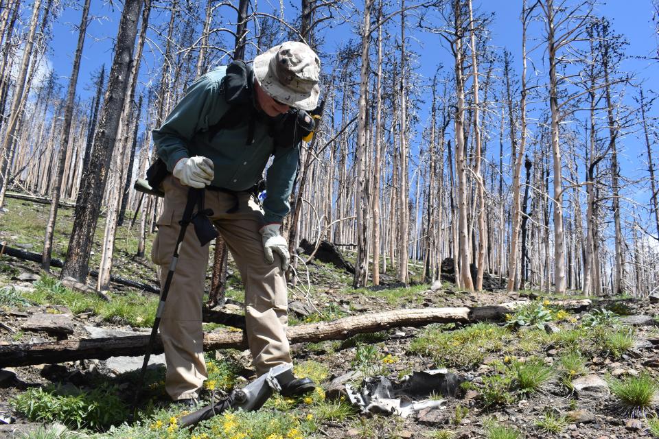 Ron Miller stops to analyze a remnant of United Airlines Flight 610, which crashed into Crystal Mountain on June 30, 1951, during a hike on June 1. The crash site remains west of Fort Collins, drawing hikers and hobbyist wreck chasers to see what is left after 71 years.