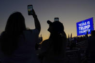 FILE - People hold their cellphones as they wait for the plane carrying former President Donald Trump to take off after a campaign rally at Waco Regional Airport Saturday, March 25, 2023, in Waco, Texas. Brad Parscale, the digital campaign operative who helped engineer Trump’s 2016 presidential victory, vows that his new, AI-powered platform will dramatically overhaul how campaigns are run. (AP Photo/Nathan Howard, File)