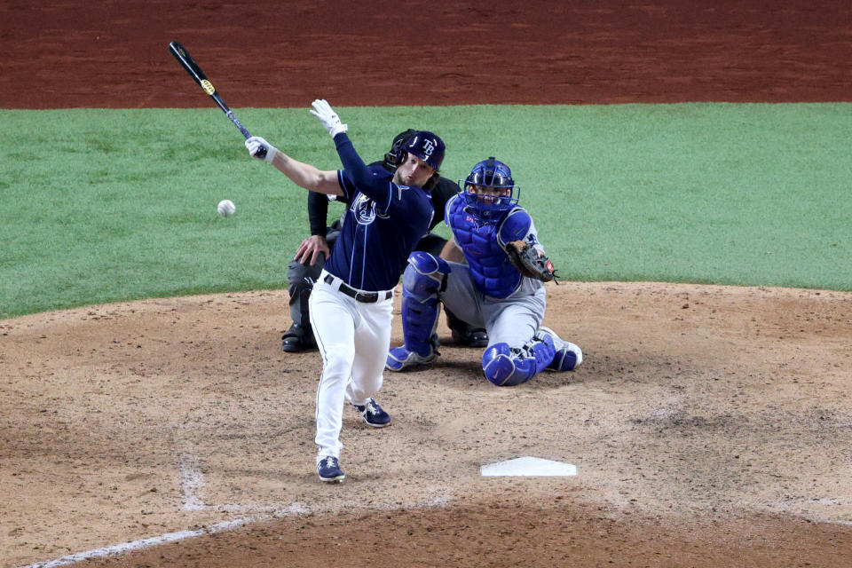 ARLINGTON, TEXAS - OCTOBER 24:  Brett Phillips #14 of the Tampa Bay Rays hits a ninth inning two-run walk-off single to defeat the Los Angeles Dodgers 8-7 in Game Four of the 2020 MLB World Series at Globe Life Field on October 24, 2020 in Arlington, Texas. (Photo by Sean M. Haffey/Getty Images)