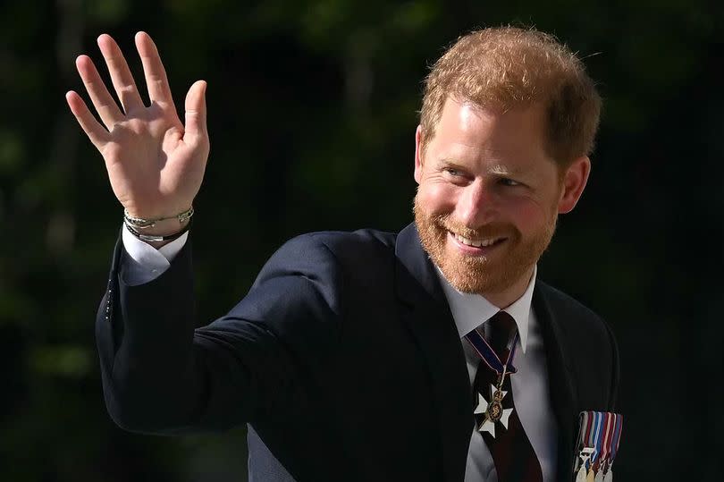 Prince Harry, Duke of Sussex waves as he arrives to attend a ceremony marking the 10th anniversary of the Invictus Games, at St Paul's Cathedral in central London, on May 8, 2024