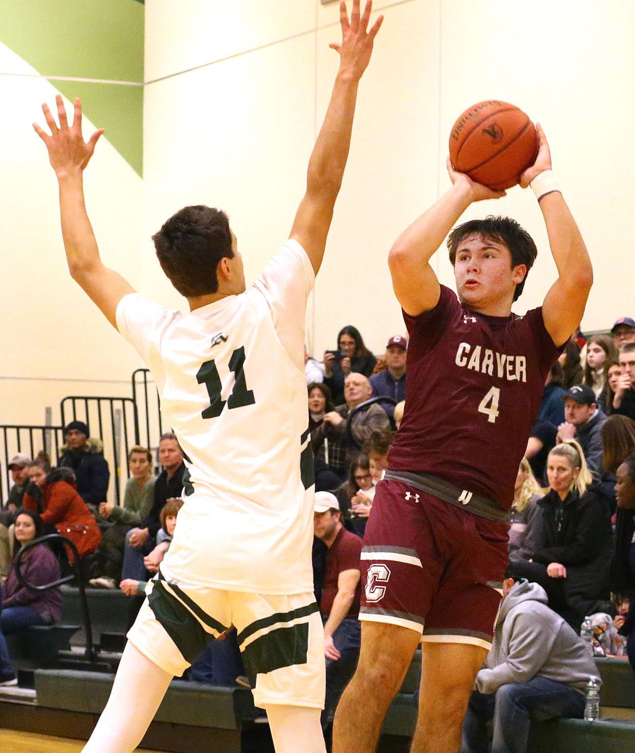 Carvers Tyler Lennox takes a fall away jumper past Abington's Kingston Maxwell.

The Abington Green Wave hosted the Carver Crusaders in boys basketball on Friday Dec. 22, 2023