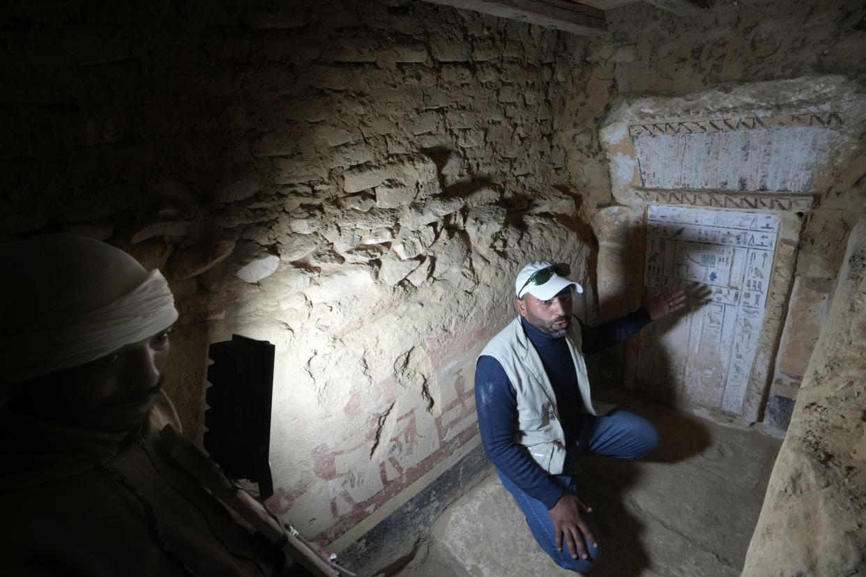 An Egyptian archeologist speaks at a recently discovered tomb dated to the Old Kingdom, 2700–2200 BC, at the site of the Step Pyramid of Djoser in Saqqara, 24 kilometers (15 miles) southwest of Cairo, Egypt, Thursday, Jan. 26, 2023. Egyptian archaeologist Zahi Hawass, the director of the Egyptian excavation team, announced that the expedition found a group of Old Kingdom tombs dating to the fifth and sixth dynasties of the Old Kingdom, indicating that the site comprised a large cemetery. (AP Photo/Amr Nabil)