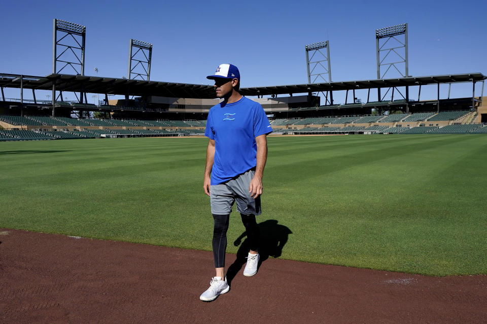 Israel Olympic baseball player Ian Kinsler walks along the outfield warning track at Salt River Fields spring training facility, Wednesday, May 12, 2021, in Scottsdale, Ariz. Israel has qualified for the six-team baseball tournament at the Tokyo Olympic games which will be its first appearance at the Olympics in any team sport since 1976. (AP Photo/Matt York)