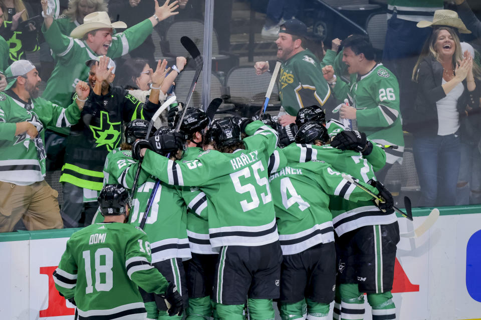 Dallas Stars celebrate Joe Pavelski's overtime goal against the Vegas Golden Knights in Game 4 of the NHL hockey Stanley Cup Western Conference finals Thursday, May 25, 2023, in Dallas. (AP Photo/Gareth Patterson)