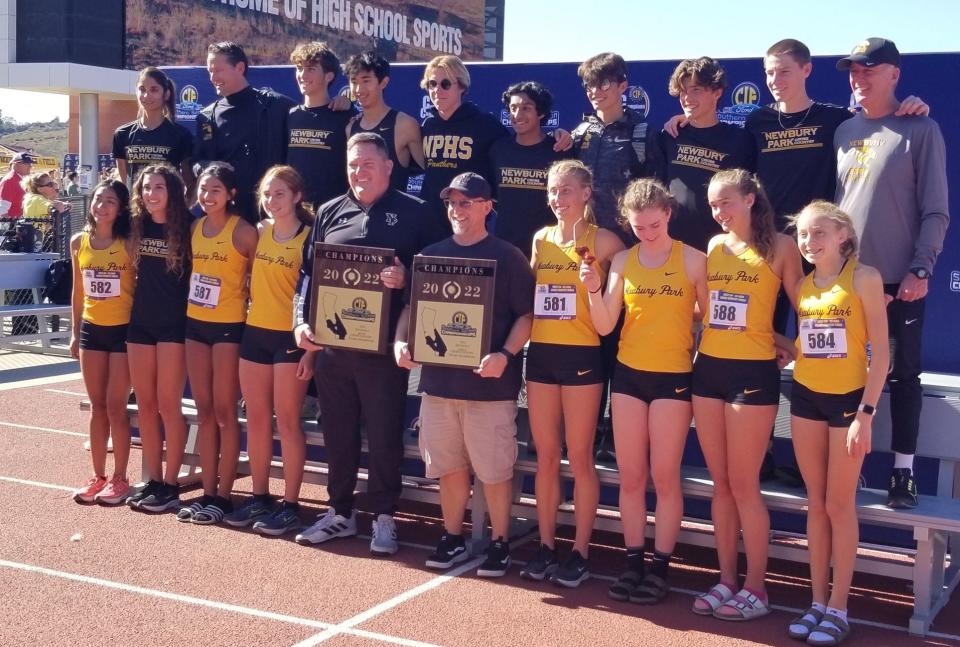 The Newbury Park boys and girls cross country teams pose with their championship plaques after winning Division 2 titles at the CIF-SS finals Saturday at Mount San Antonio College. Both teams qualified for the state meet.